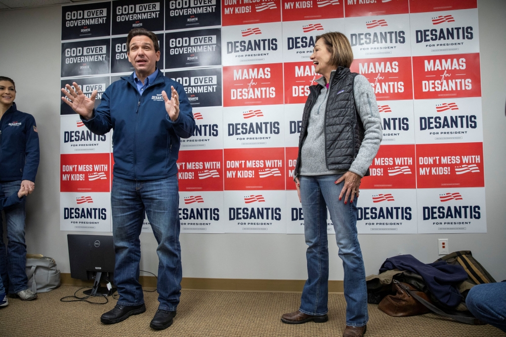 Iowa Governor Kim Reynolds and Republican presidential candidate Florida Governor Ron DeSantis make remarks at DeSantis’ Iowa campaign headquarters in Urbandale, Iowa, US, January 12, 2024. — Reuters pic