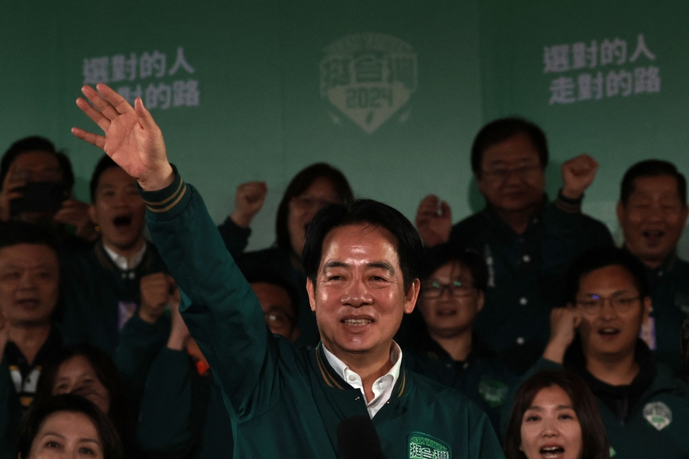 Taiwan’s President-elect Lai Ching-te (left) gestures beside his running mate Hsiao Bi-khim during a rally outside the headquarters of the Democratic Progressive Party (DPP) in Taipei on January 13, 2024, after Lai won the presidential election. — AFP pic