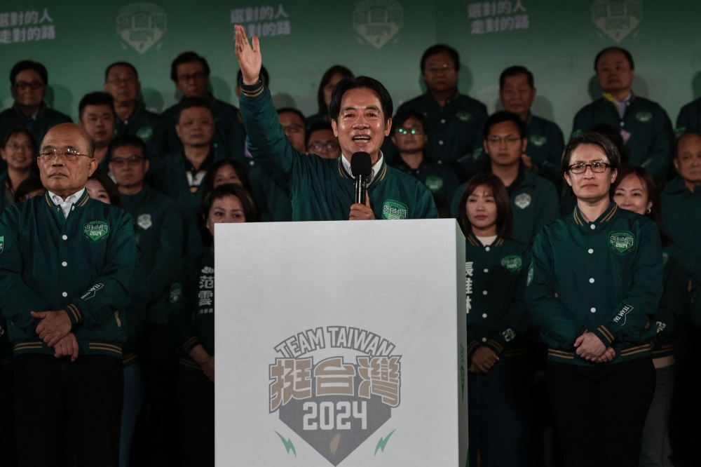 Taiwan’s President-elect Lai Ching-te (centre) addresses supporters as he stands with his running mate Hsiao Bi-khim (right) during a rally outside the headquarters of the Democratic Progressive Party (DPP) in Taipei on January 13, 2024, after Lai won the presidential election. — AFP pic