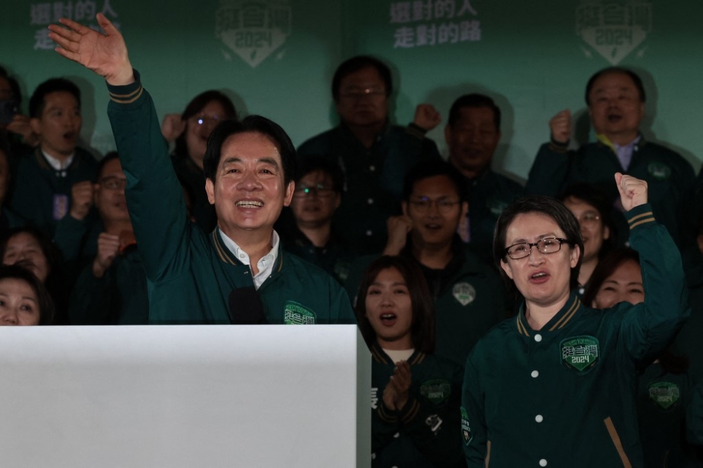 Taiwan’s President-elect Lai Ching-te (left) waves beside his running mate Hsiao Bi-khim during a rally outside the headquarters of the Democratic Progressive Party (DPP) in Taipei on January 13, 2024, after winning the presidential election. — AFP pic