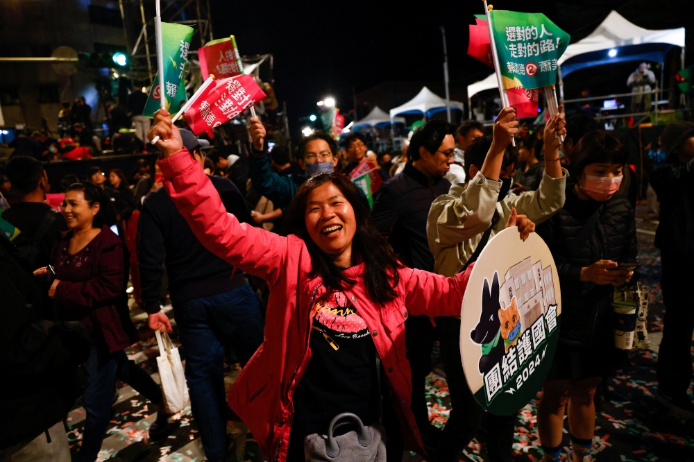 A supporter of the Democratic Progressive Party (DPP) dances during a rally, following the victory of Lai Ching-te in the presidential elections, in Taipei, Taiwan January 13, 2024. — Reuters pic