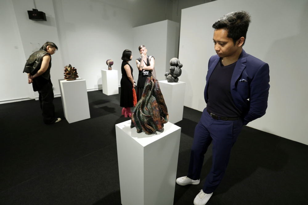 Visitors look at exhibits during the ‘Life: Magnified — The Main Show’ exhibition at Zhan Art in Kuala Lumpur January 13, 2024. — Bernama pic