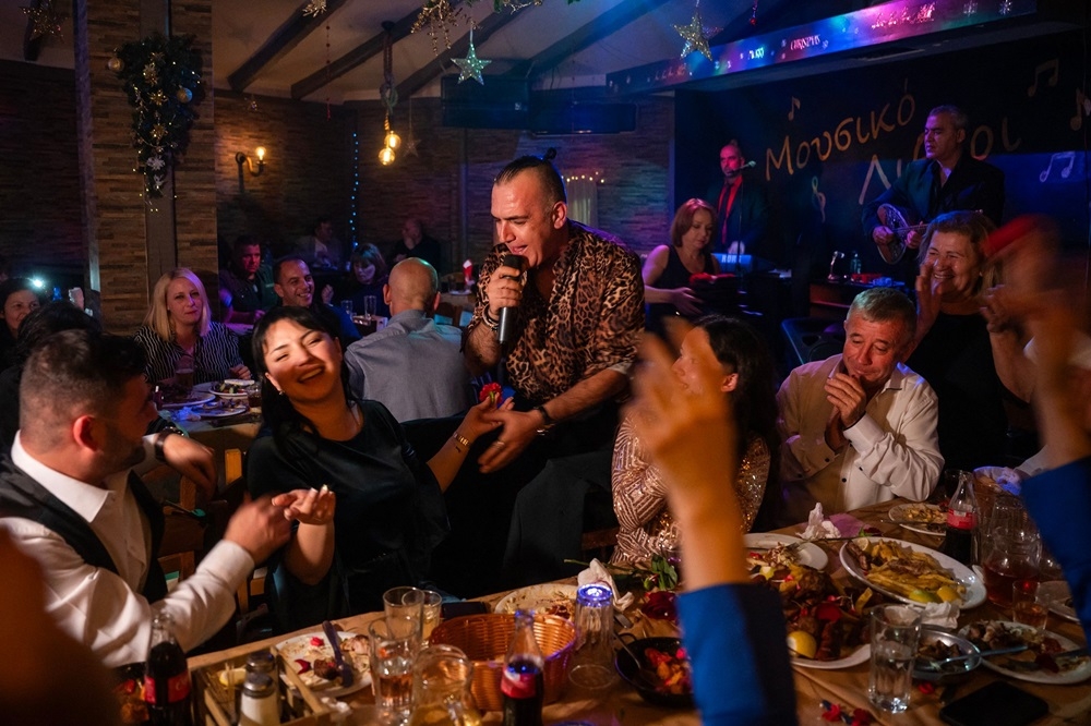 A singer performing at clients’ table at a Greek nightclub in the western suburbs of Athens. — AFP pic 