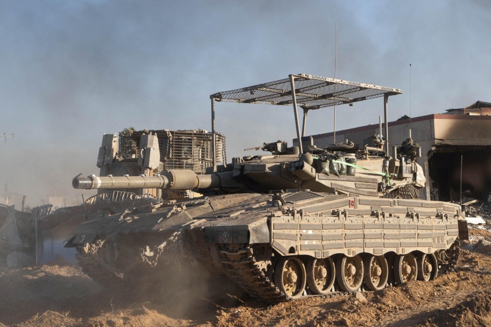 A Merkava tank is seen as Israeli soldiers operate in the Gaza Strip amid the ongoing conflict between Israel and the Palestinian Islamist group Hamas, in this handout picture released on January 14, 2024. — Israel Defence Force handout via Reuters pic