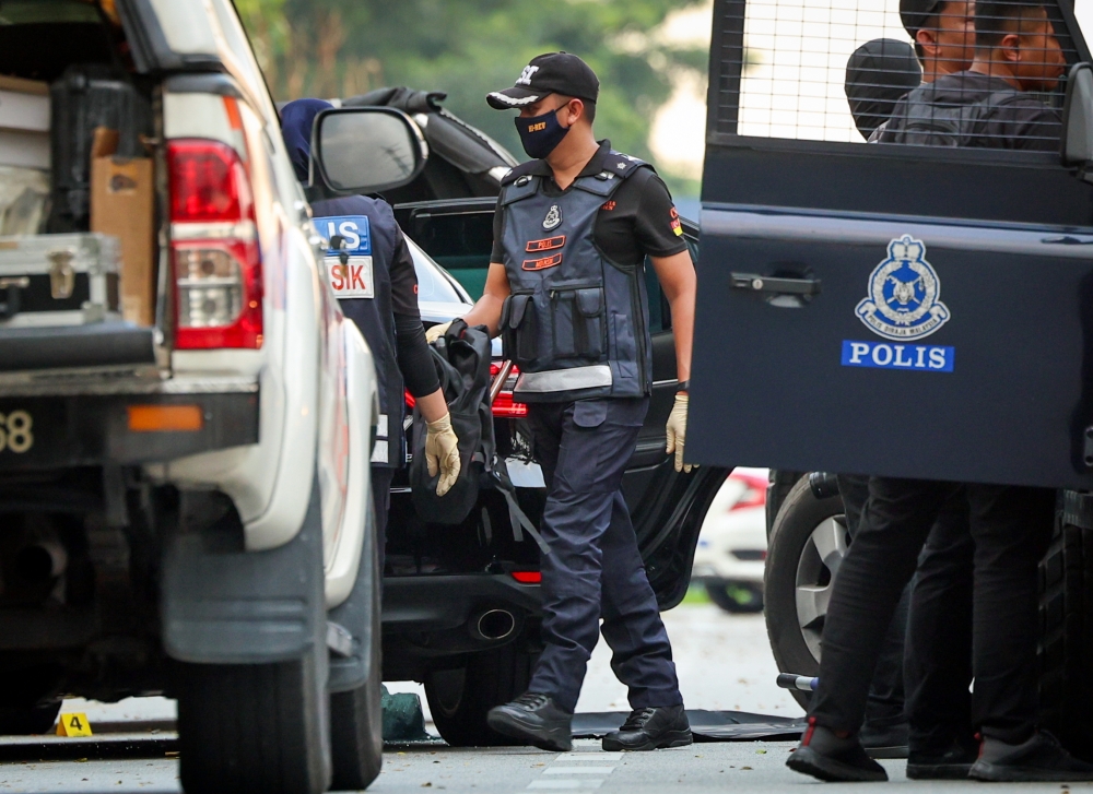Forensics police gather evidence after a man, believed to have been shot dead, was found inside a car on the road shoulder in Puchong Prima January 14, 2024. — Bernama pic
