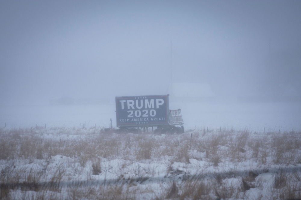 A campaign billboard of Republican presidential candidate and former US President Donald Trump is seen ahead of the Iowa caucus vote, outside Colfax, Iowa January 13, 2024. — Reuters pic