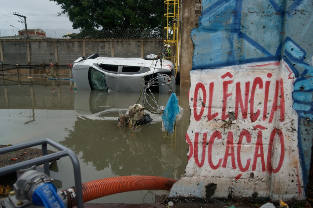 Picture of a car in the water heavy rains during the night caused destruction in the suburbs of Rio de Janeiro, Brazil, on January 14, 2024. — AFP pic