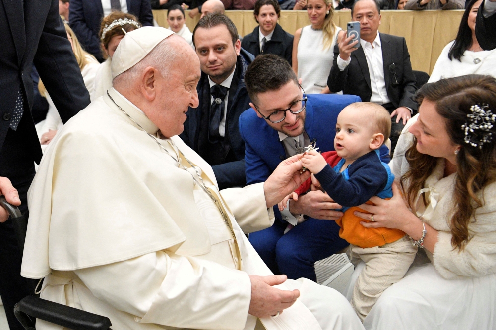 Pope Francis meets a child during his weekly general audience at the Vatican, January 10, 2024. — Vatican Media/­Handout via Reuters pic