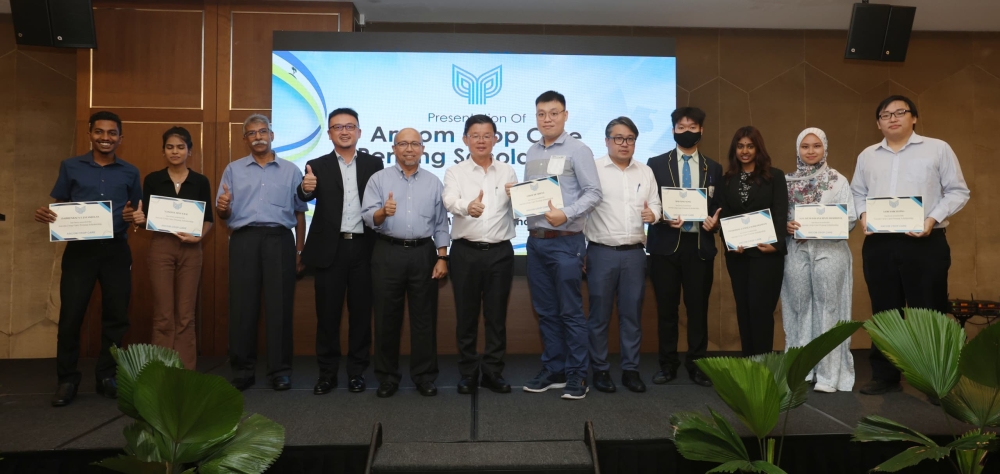 Penang Chief Minister Chow Kon Yeow (5th left), Ancom Crop Care chairman Datuk  Abd Hapiz Abdullah (4th left), and Ancom Crop Care CEO Lee Cheun Wei (3rd left) with nine of the scholarship recipients.  — Picture by Opalyn Mok