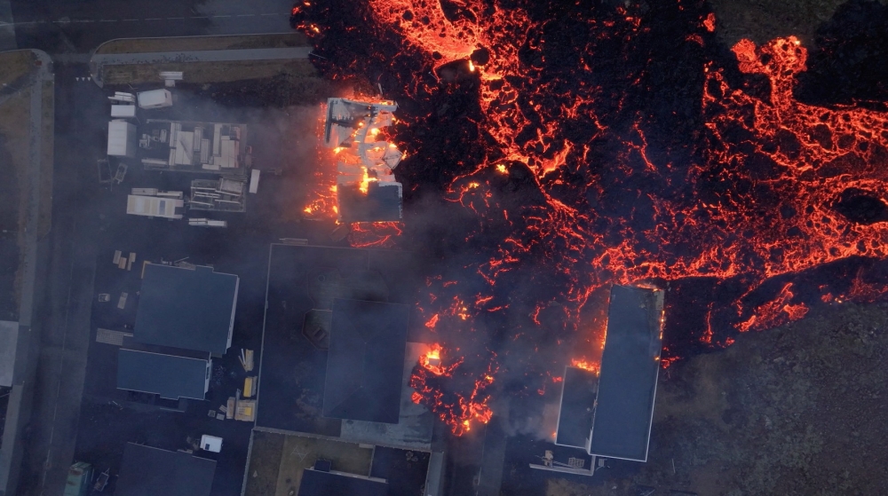 Lava flows from a volcano as houses burn in Grindavik, Iceland, January 14, 2024, in this screen grab obtained from a social media video. — Bjorn Steinbekk/@bsteinbekk via Instagram/Reuters