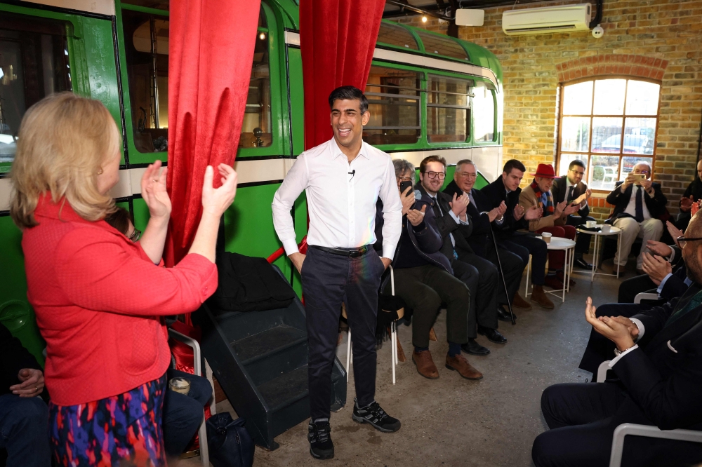Britain's Prime Minister Rishi Sunak speaks with members of the local community during a visit of the fish processing plant and its surroundings, in Leigh-on-Sea, southeast of England, on January 15, 2024. ― AFP pic