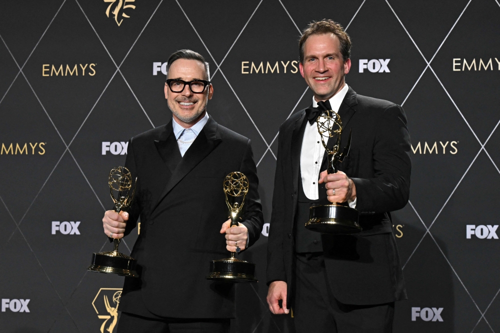 Canadian-British filmmaker David Furnish (left) and Luke Lloyd-Davies pose in the press room with the Outstanding Variety Special (Live) award for ‘Elton John Live: Farewell from Dodger Stadium’ during the 75th Emmy Awards at the Peacock Theatre in Los Angeles January 15, 2024. ― AFP pic