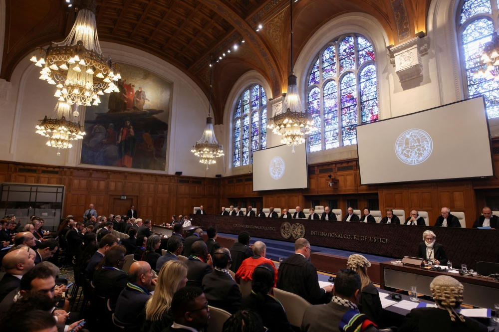 People sit inside the International Court of Justice (ICJ) on the day of the trial to hear a request for emergency measures by South Africa, who asked the court to order Israel to stop its military actions in Gaza and to desist from what South Africa says are genocidal acts committed against Palestinians during the war with Hamas in Gaza, in The Hague, Netherlands, January 11, 2024. — Reuters pic
