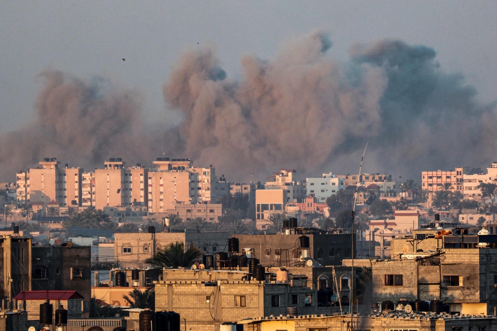 This picture taken from Rafah shows smoke billowing over Khan Yunis in the southern Gaza Strip during Israeli bombardment on January 16, 2024, amid ongoing battles between Israel and Hamas. ― AFP pic