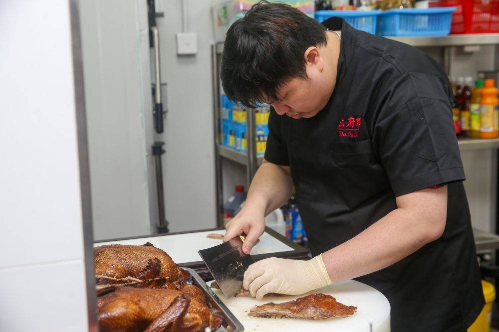 The braised duck is cut just before serving.