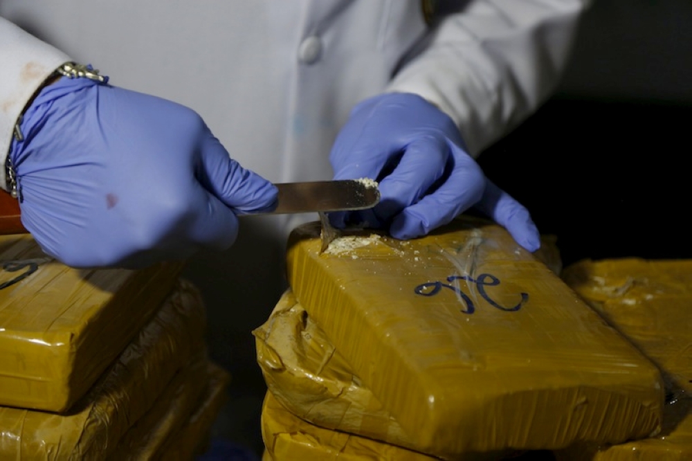 File picture of an anti-narcotics police chemist testing cocaine from a seized brick in Lima February 29, 2016. The Royal Malaysian Customs Department foiled an attempt to smuggle in 6.13 kilogrammes of cocaine worth RM1.22 million that was hidden inside the hand carry luggage of a passenger at Terminal 1 of KLIA in Sepang January 9. — Reuters pic