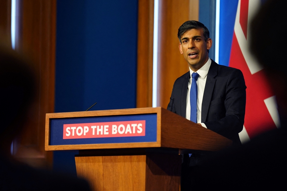 Britain's Prime Minister Rishi Sunak hosts a press conference inside the Downing Street Briefing Room, in central London, on December 7, 2023, after Britain and Rwanda sign a new treaty to transfer illegal migrants to the African country. — AFP pic