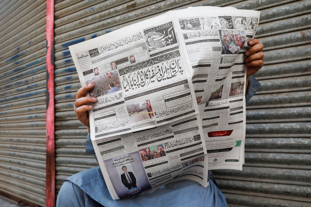 A man reads a newspaper, after the Pakistani foreign ministry said the country conducted strikes targeting separatist militants inside Iran, along a road in Karachi, Pakistan January 18, 2024. — Reuters pic