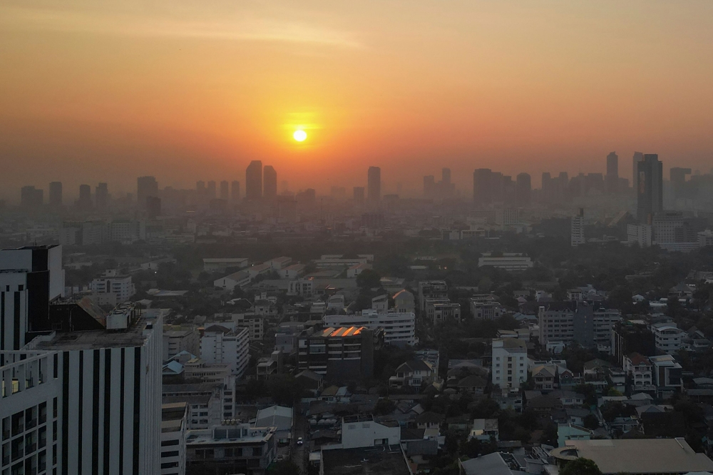 This aerial photo shows sunrise amid high levels of air pollution in Bangkok January 9, 2024. — AFP pic 