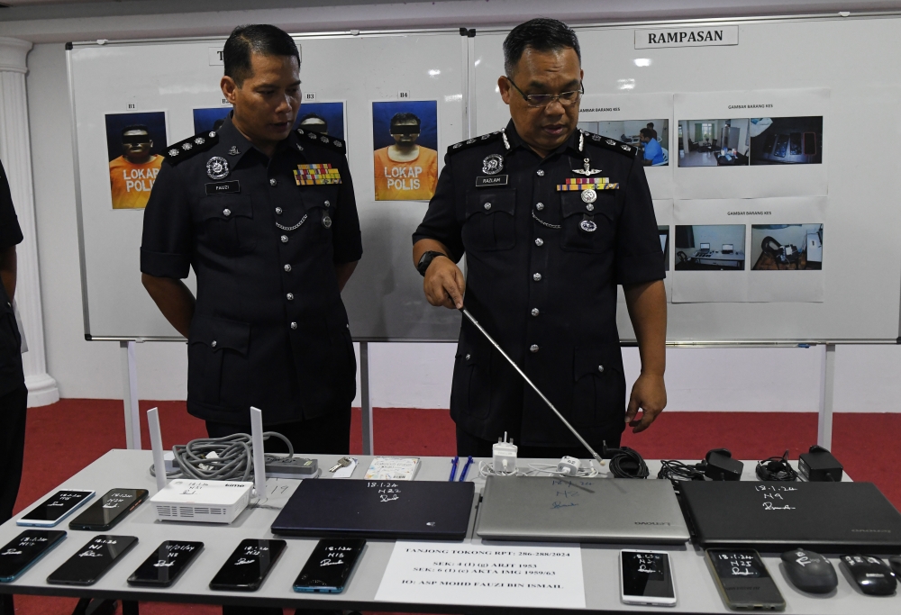 Timur Laut District Police Chief ACP Razlam Ab Hamid shows items seized during a raid on an apartment in Tanjung Tokong, Penang January 19, 2024. — Bernama pic