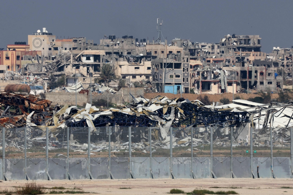 A picture taken from a position in southern Israel on January 19, 2024, shows damaged or levelled buildings in the Gaza Strip amid continuing battles between Israel and Hamas. A UN human rights official accused Israel today of mistreating Palestinian detainees in Gaza, saying he had met men who had described being held for weeks, beaten and blindfolded, with some released in diapers. — AFP pic 