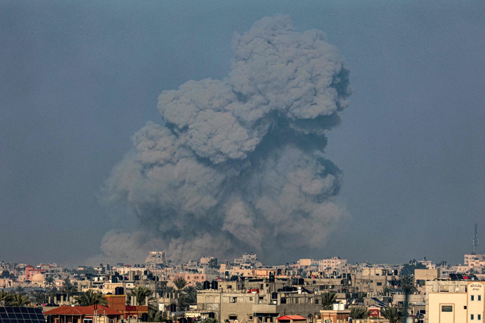 A picture taken from Rafah shows smoke billowing over Khan Yunis in the southern Gaza Strip during Israeli bombardment on January 19, 2024, amid ongoing battles between Israel and Hamas. Gaza residents have been largely without internet and telephone services for a week, an internet monitor said today, the longest outage since the Israel-Hamas war broke out on October 7. — AFP pic 
