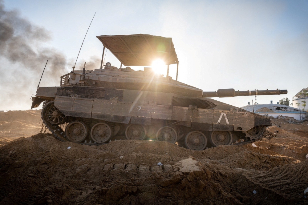Israeli soldiers operate a tank in the Gaza Strip, amid the ongoing conflict between Israel and the Palestinian Islamist group Hamas, in this handout picture released on January 20, 2024. — Israel Defense Forces/Handout via Reuters pic