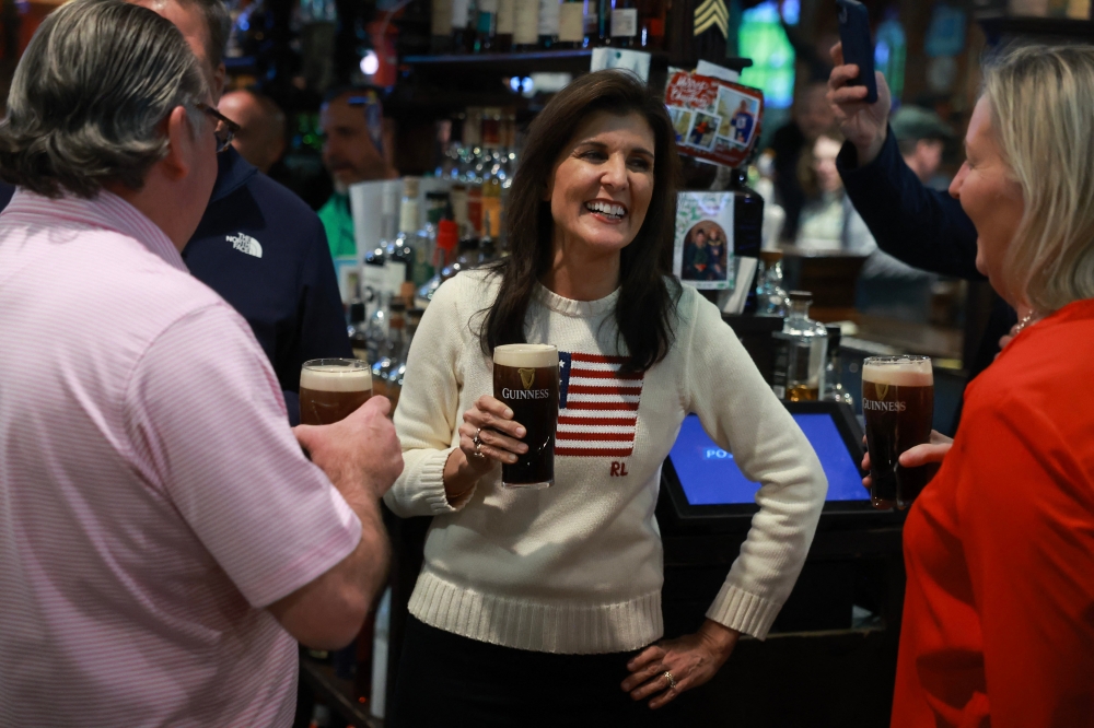 Republican presidential candidate former UN Ambassador Nikki Haley enjoys a beer as she visits The Peddler’s Daughter on January 20, 2024 in Nashua, New Hampshire. — AFP pic