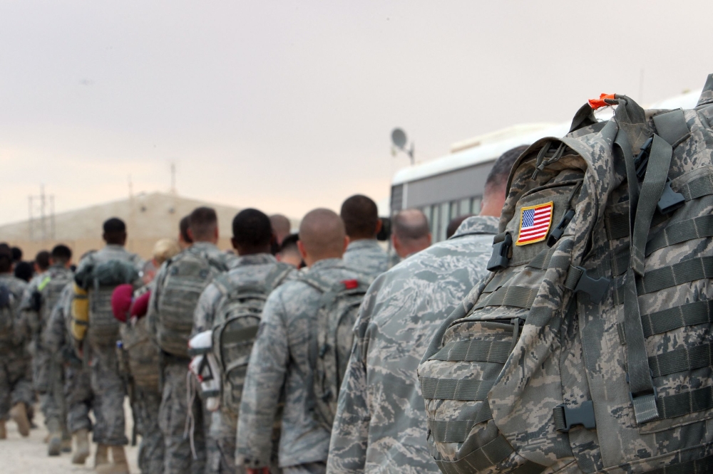 File photo of US army soldiers queueing to board a plane to begin their journey home out of Iraq from the al-Asad Air Base west the capital Baghdad, on November 1, 2011. — AFP pic