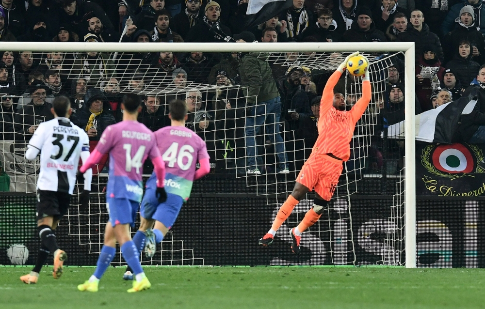 Fans aimed monkey chants at AC Milan and France goalkeeper Mike Maignan during Milan’s dramatic 3-2 win at Udinese, with the game temporarily halted. — Reuters pic 