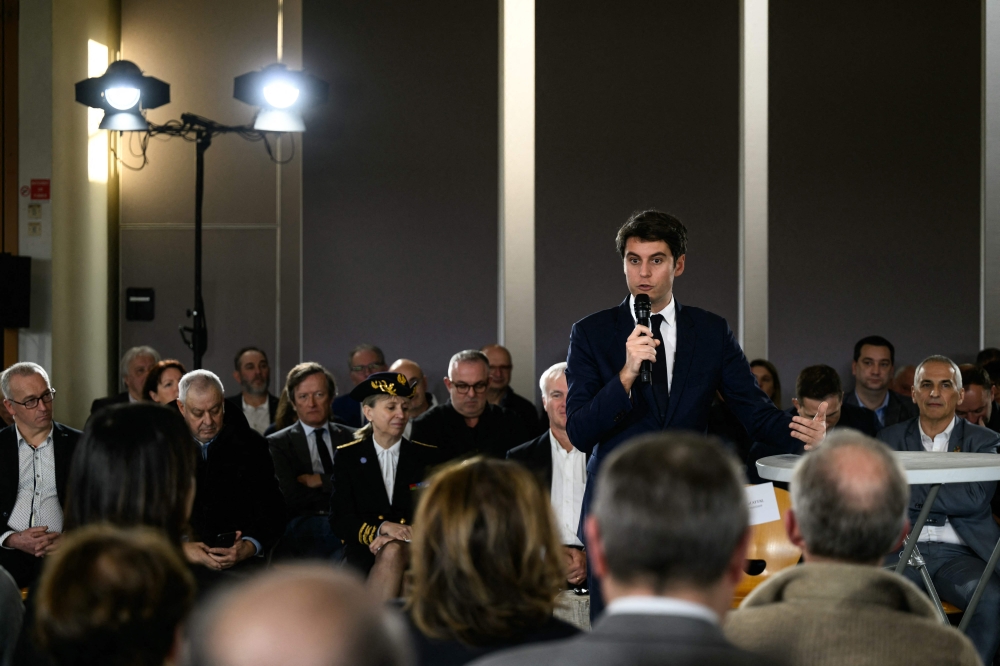French Prime Minister Gabriel Attal (centre right) attends a debate with the mayors and residents of the Rhone department, in Saint-Laurent d’Agny, central France, on January 20, 2024. — AFP pic
