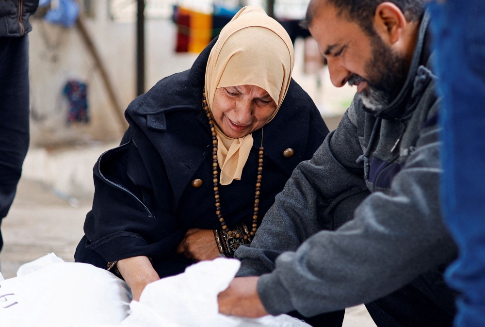 Mourners react next to the body of a relative, amid the ongoing conflict between Israel and the Palestinian Islamist group Hamas, in Rafah in the southern Gaza Strip, January 21, 2024. — Reuters pic