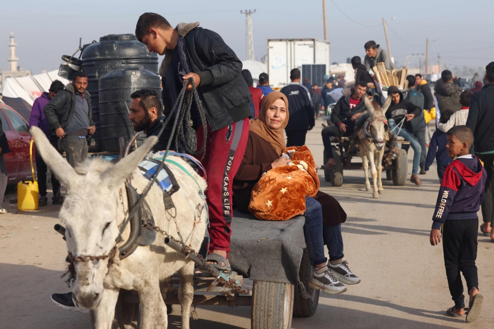 Displaced Palestinians use a donkey cart for transportation at a makeshift tent camp in Rafah near the border with Egypt in the southern Gaza Strip on January 21, 2024 amid the ongoing conflict between Israel and the Palestinian militant group Hamas. —  AFP pic