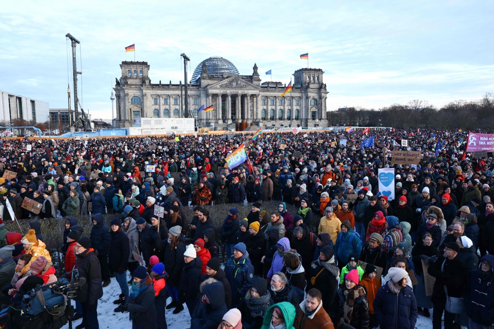Participants gather during a demonstration against racism and far right politics in front of the Reichstag building in Berlin, Germany on January 21, 2024. — AFP pic