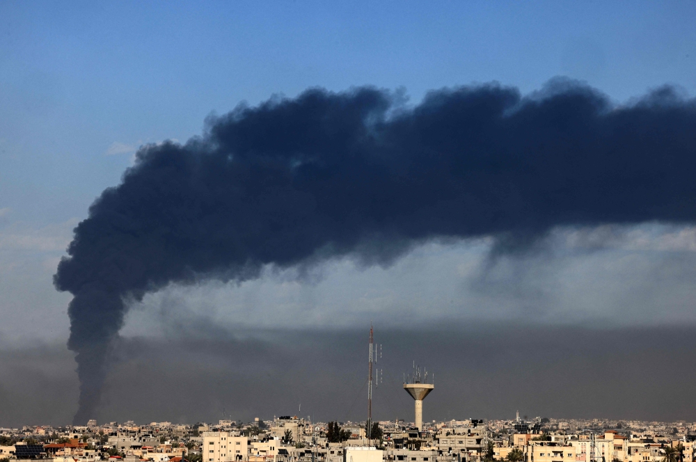 A picture taken from Rafah shows smoke billowing over Khan Yunis in the southern Gaza Strip during Israeli bombardment on January 21, 2024, amid ongoing battles between Israel and the Palestinian militant group Hamas. — AFP pic
