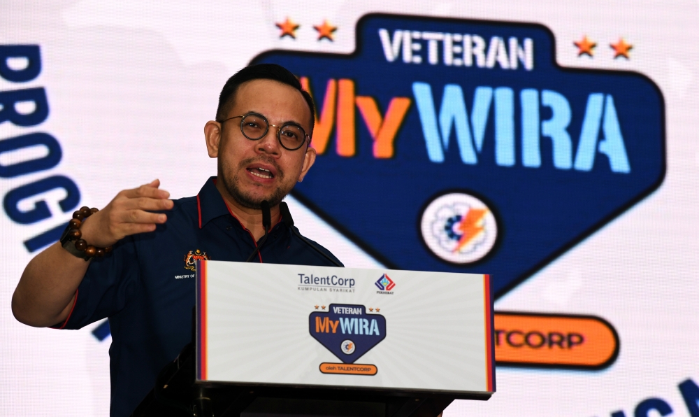 Minister of Human Resources Steven Sim Chee Keong delivers a speech during the launch of the Veteran MyWIRA Initiative at the Spice Arena Convention Centre in George Town January 22, 2024. — Bernama pic
