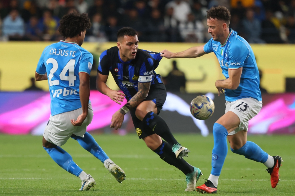 Napoli's Kosovo defender Amir Rrahmani (right) and Napoli's Swedish midfielder Jens Cajuste (left) mark Inter Milan's Argentine forward Lautaro Martinez (centre) during the Italian Super Cup final football match between Napoli and Inter Milan at Al-Awwal Park Stadium in Riyadh January 22, 2024. — AFP pic