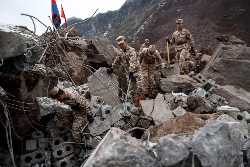 Chinese military personnel and rescue workers search for missing victims following a landslide in Liangshui village at Zhaotong, in southwestern China's Yunnan province January 22, 2024. — AFP pic