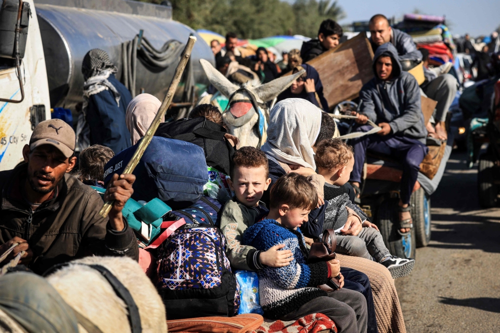 This photograph taken on January 22, 2024 on the southern outskirts of Khan Yunis, in the southern Gaza Strip, shows Palestinian families fleeing the city on the coastal road leading to Rafah, amid ongoing battles between Israel and the Palestinian group Hamas. — AFP pic