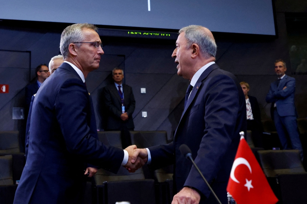 Nato Secretary General Jens Stoltenberg and Turkey's Defence Minister Hulusi Akar attend North Atlantic Council during a Nato defence ministers meeting, with Finland and Sweden as invitees, at the Alliance's headquarters in Brussels, Belgium October 13, 2022. — Reuters pic
