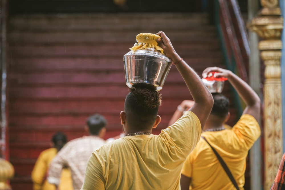 Hindu devotees carry milk pots ahead of the Thaipusam festival at Batu Caves temple in Kuala Lumpur, January 23, 2024. — Picture by Raymond Manuel