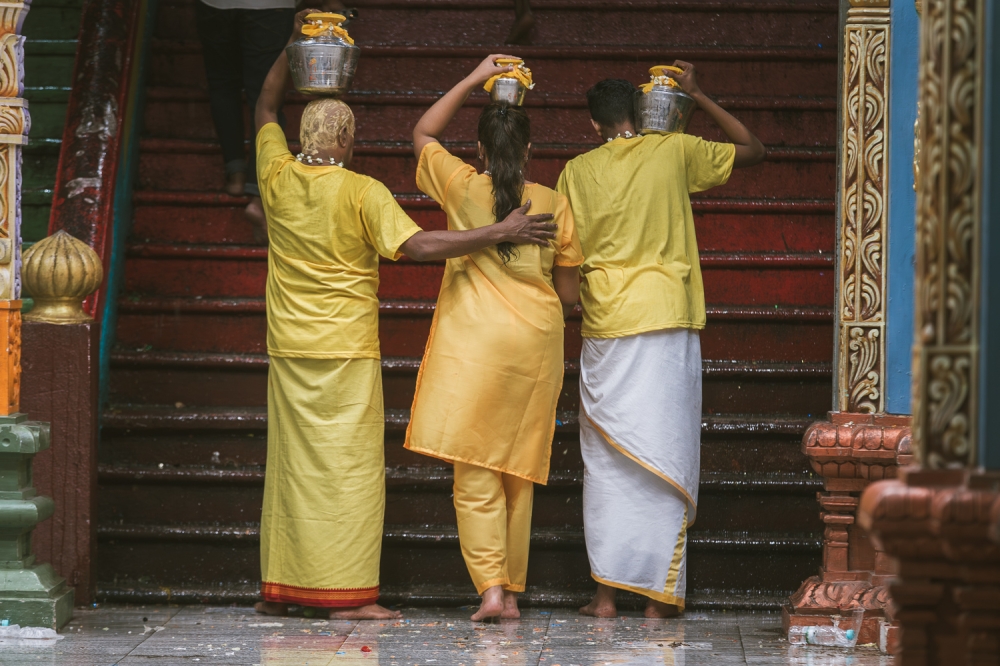 Hindu devotees carry milk pots ahead at Batu Caves temple. — Picture by Raymond Manuel