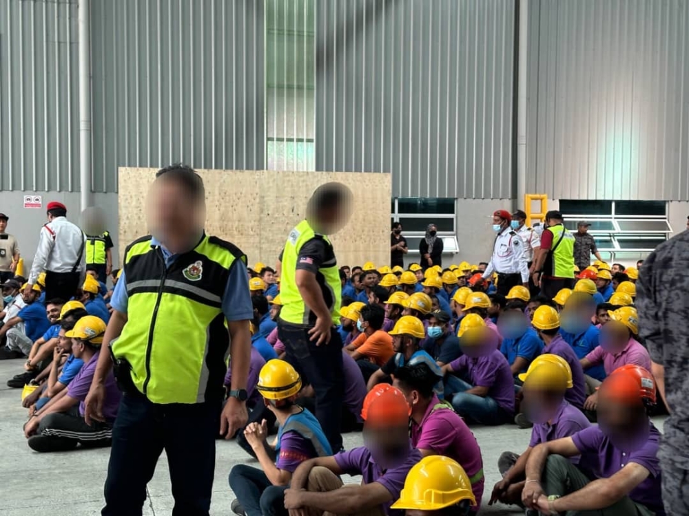 Johor Immigration enforcers conducting checks on foreign migrant workers during a raid at a factory in Senai near Johor Baru January 25, 2024 — Picture courtesy of the Johor Immigration Department