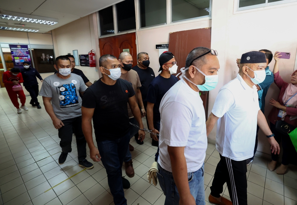 Former Eastern Sabah Security Command (Esscom) Head of Intelligence Staff SAC Datuk Mat Zaki Md Zain (right) along with 6 ESSCom members and a civilian Vivian Fabian (left) at the High Court in Tawau, January 2, 2023. — Bernama pic