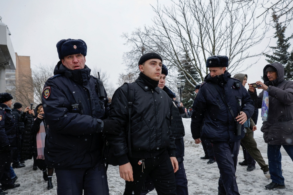 Police officers detain a supporter of Russian prominent nationalist, former military commander and Kremlin critic Igor Girkin, also known as Igor Strelkov, who was convicted of inciting extremism and sentenced to four years in a penal colony, after a hearing outside a court building in Moscow, Russia, January 25, 2024. — Reuters pic