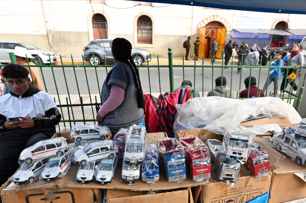 Tin cars made by inmates of the San Pedro prison are sold outside the prison in La Paz, on January 18, 2024. — AFP pic