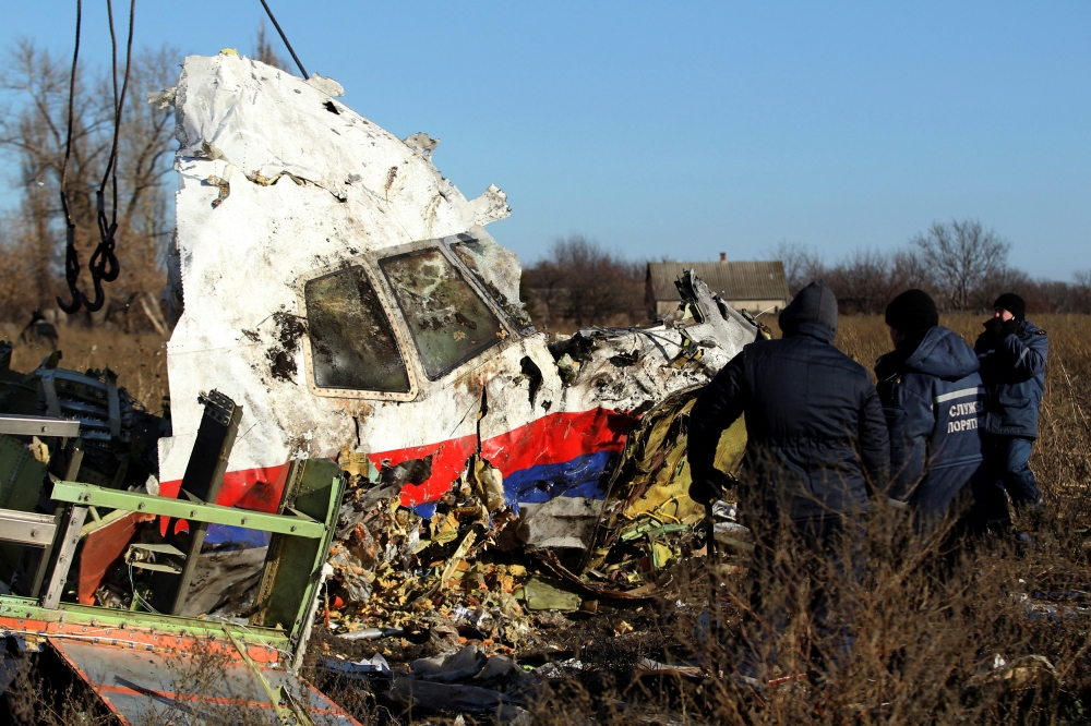 Local workers transport a piece of wreckage from Malaysia Airlines flight MH17 at the site of the plane crash near the village of Hrabove (Grabovo) in Donetsk region, eastern Ukraine November 20, 2014. ― Reuters file pic