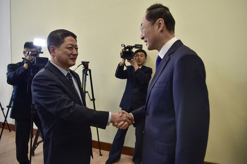 China’s Vice Foreign Minister Sun Weidong (right) shakes hands with North Korea’s Vice Foreign Minister Pak Myong-ho during a meeting at the People’s Palace of Culture in Pyongyang on January 26, 2024. — AFP pic