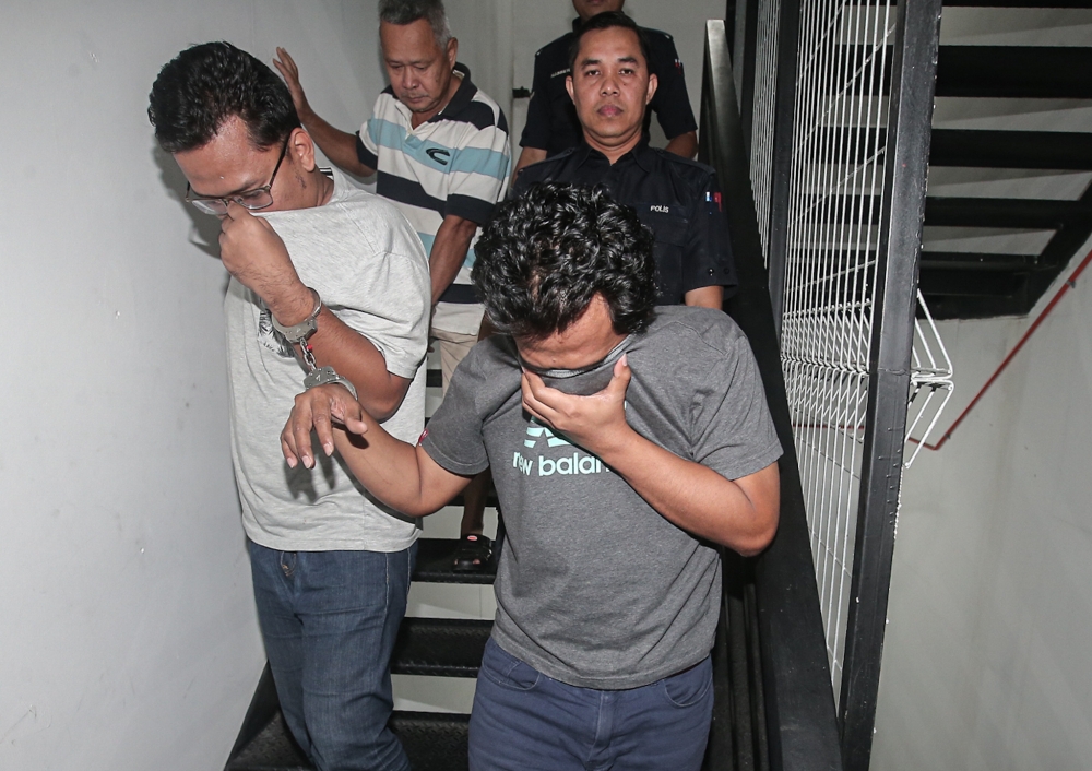 Heidil Iskandar Mohd Shamlan, 33, and Mohd Zulkifli Mohd Toha, 45, pleaded not guilty to the charges before Judge Norita Mohd Ardani. — Picture by Farhan Najib