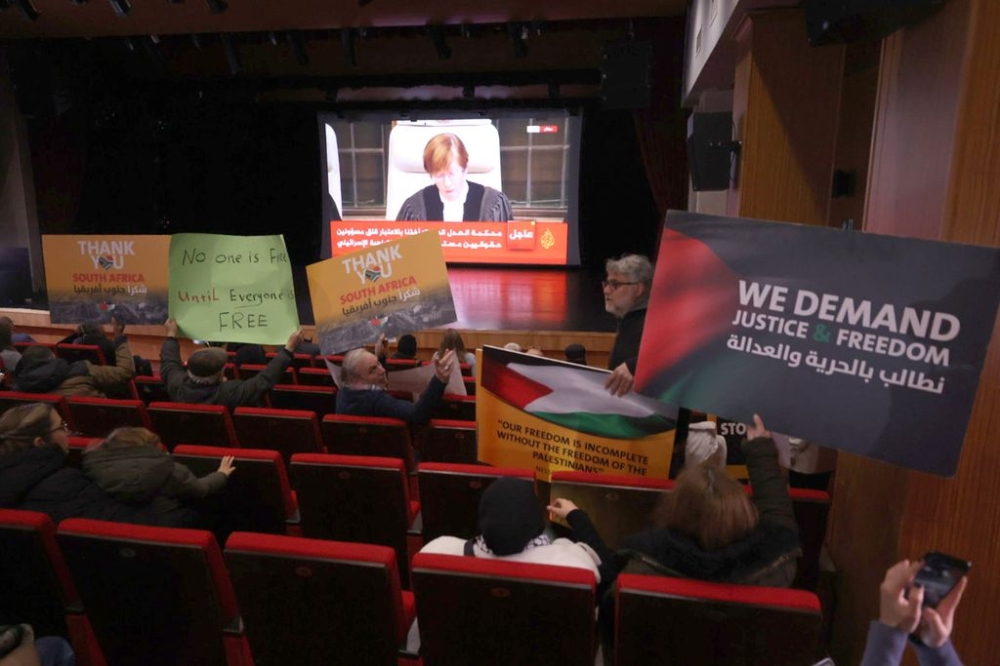 Palestinians and press members gather to watch the International Court of Justice (ICJ) rule on Gaza genocide case against Israel made by South Africa at the City Hall in Ramallah, West Bank on January 26, 2024. — Anadolu/Reuter pic